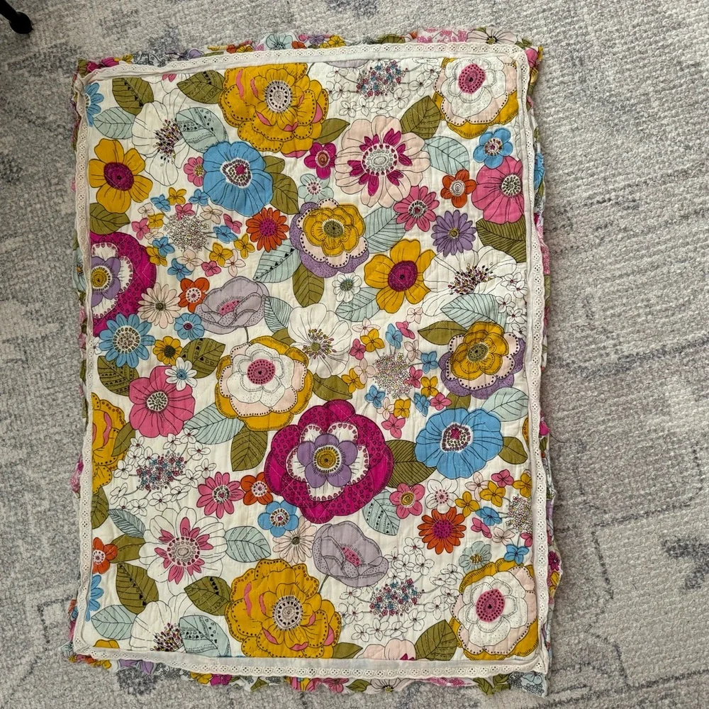 Cynthia Rowley quilted pillow sham with a multicolored boho floral pattern.